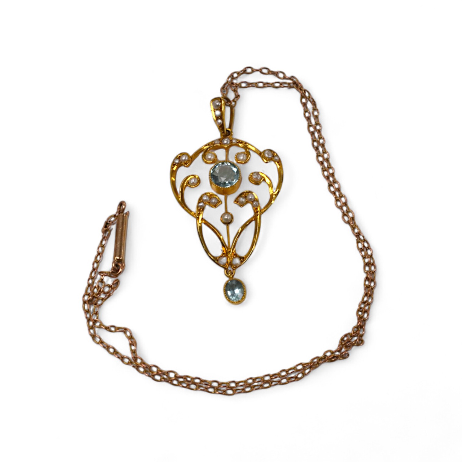 An Edwardian 9ct and gem set drop pendant, 45mm, on a yellow metal fine link chain, 36cm, gross weight 4.2 grams. Condition - good